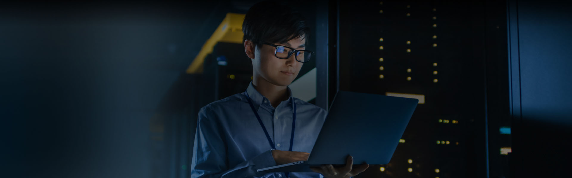Geek technician looking at a laptop